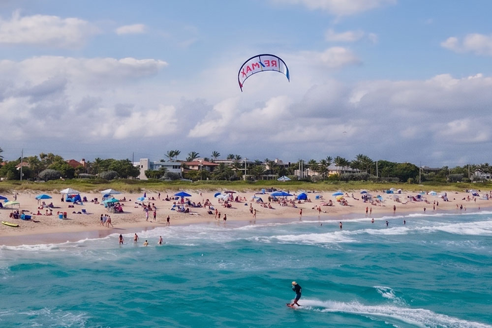KiteBanner flying over a crowded beach